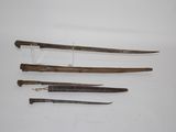 three different types of swords are displayed on a white surface
