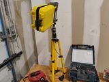a yellow tripod and a laptop on a workbench
