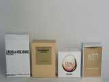 three boxes of perfume sitting next to each other on a white surface