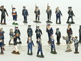 many figurines of men in uniform on a shelf