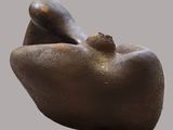 a sculpture of a woman laying on her back