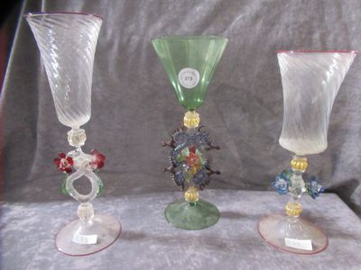 three glass vases that are sitting on a table