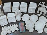 a lot of white ceramic figurines sitting on a table