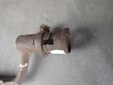 a rusted pipe that has a tag on it