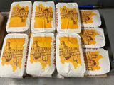 a tray of cakes that have been wrapped in yellow icing