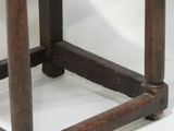 a small wooden table with a glass top on a white surface