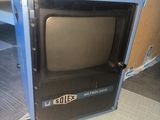 a small television sitting on top of a shelf in a room