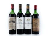 three bottles of wine are lined up on a white surface