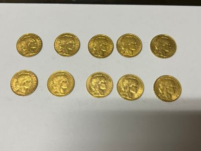 a bunch of gold coins sitting on top of a white table