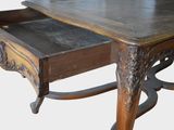 a wooden table with a drawer on top of it