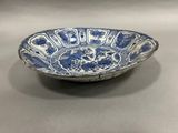 a blue and white bowl sitting on top of a table