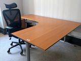 a desk with a chair in the corner of the room