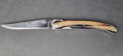 a knife that is laying on a table