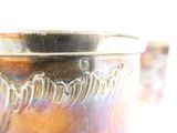 a close up of a metal vase with a design on it