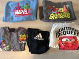 several t - shirts are lined up on the floor with the characters on them