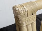 a close up of a chair made of bamboo sticks