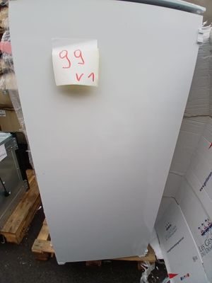 a white refrigerator sitting on a pallet in a warehouse