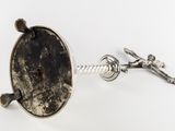 a silver object with a black stone in it