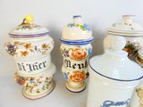 many different types of kitchen canisters on the table