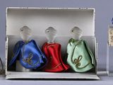 three glass figurines in a box on a table