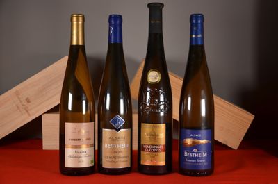 three bottles of wine are lined up on a table