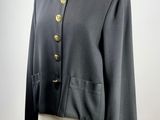 a black jacket with gold buttons on a mannequin mannequin