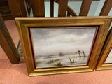 two framed pictures of a snowy landscape on the floor