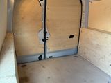 a white van with a door open in a room