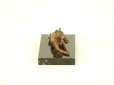 statue of a dog resting on a marble block
