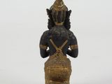 an image of a statue of a person sitting on a stool