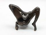 a small metal sculpture of a butterfly on a stand