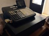 a cash register sitting on top of a wooden desk