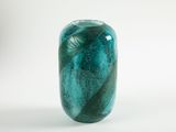 a green vase that is sitting on a white surface