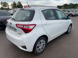 the back of a white toyota yaris parked in a parking lot
