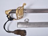 a sword with a gold handle and a tassel on it