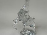 clear glass figurine of a bird on a white surface