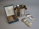 a silver ice bucket with spoons and forks in it