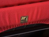 the back end of a red car with a logo on it