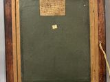 an old picture frame with a piece of paper taped to it