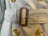 a close up of a person wearing a trench coat