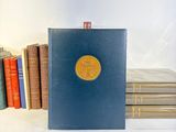 a blue book with a gold medallion on it