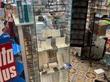 a display case in the middle of a store filled with items
