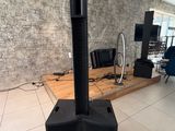 a speaker that is sitting on a stand in the room