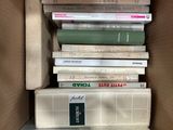 many books stacked on top of each other in a box