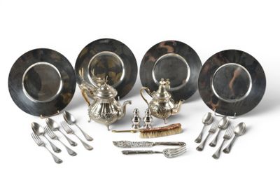 a group of silver plate and silverware on a white surface