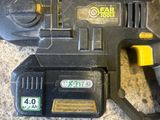 a close up of a corded drill on a carpet