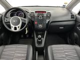 the interior of a small car with a steering wheel and dashboard controls