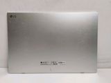 the back of a silver laptop computer sitting on top of a white surface
