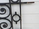 a black iron fence with a design on it