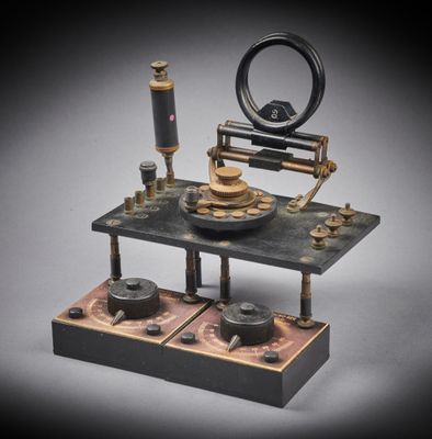 an old model of a machine with a clock on it